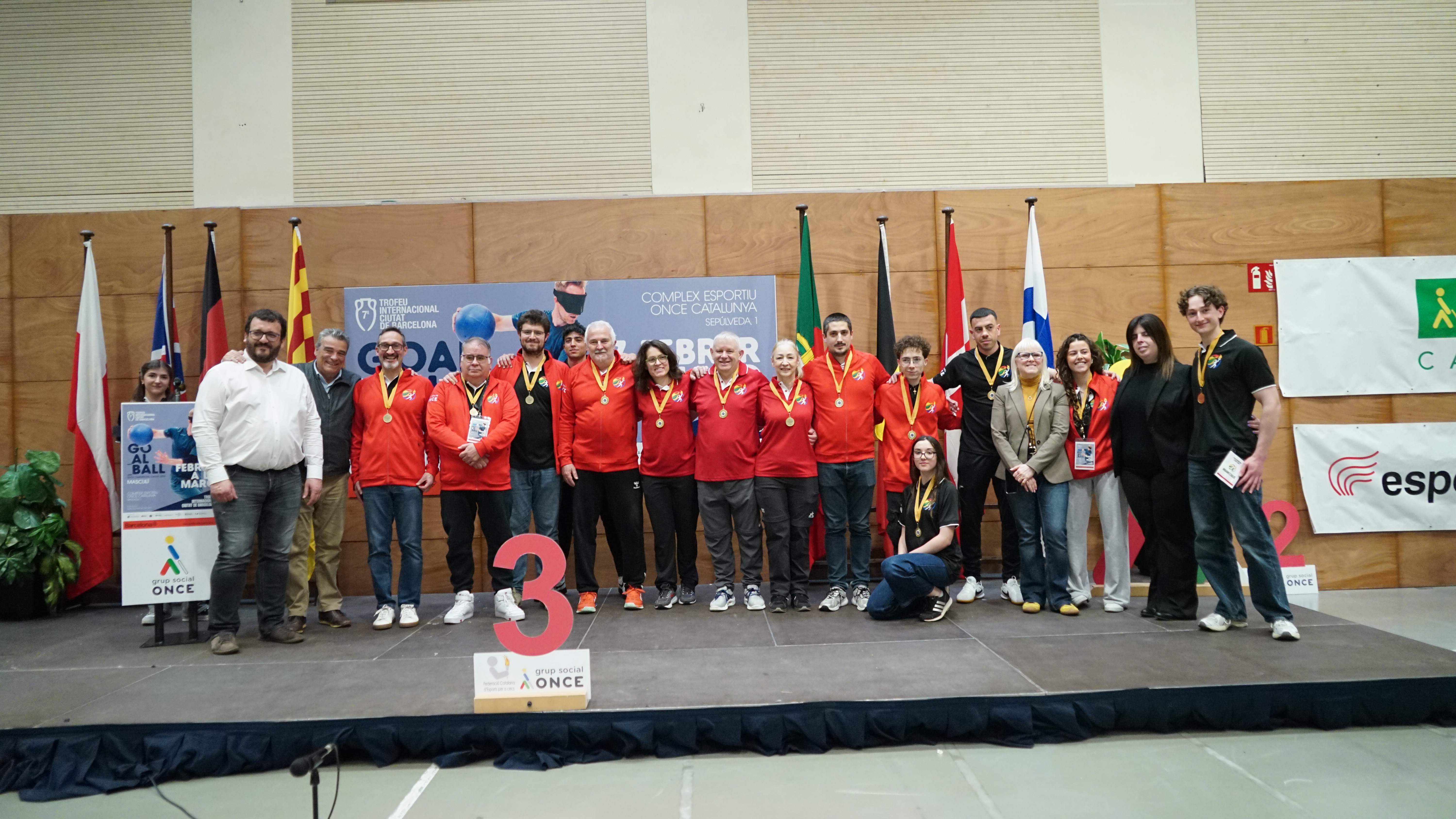 Photo of the referees on the stage on the Sunday in red jackets