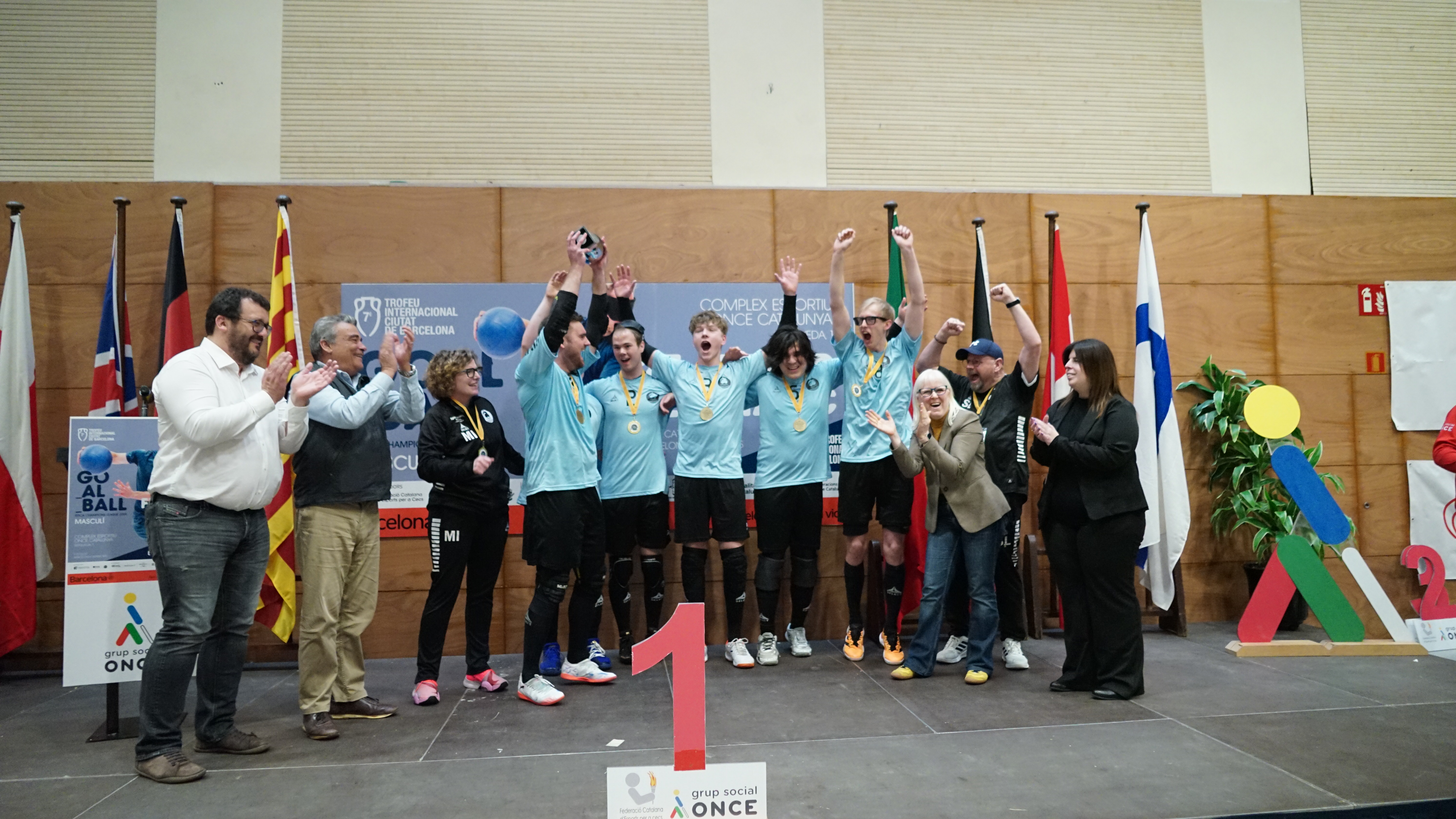 Aarhus on stage with the trophy raised in the air celebrating their first-place finish