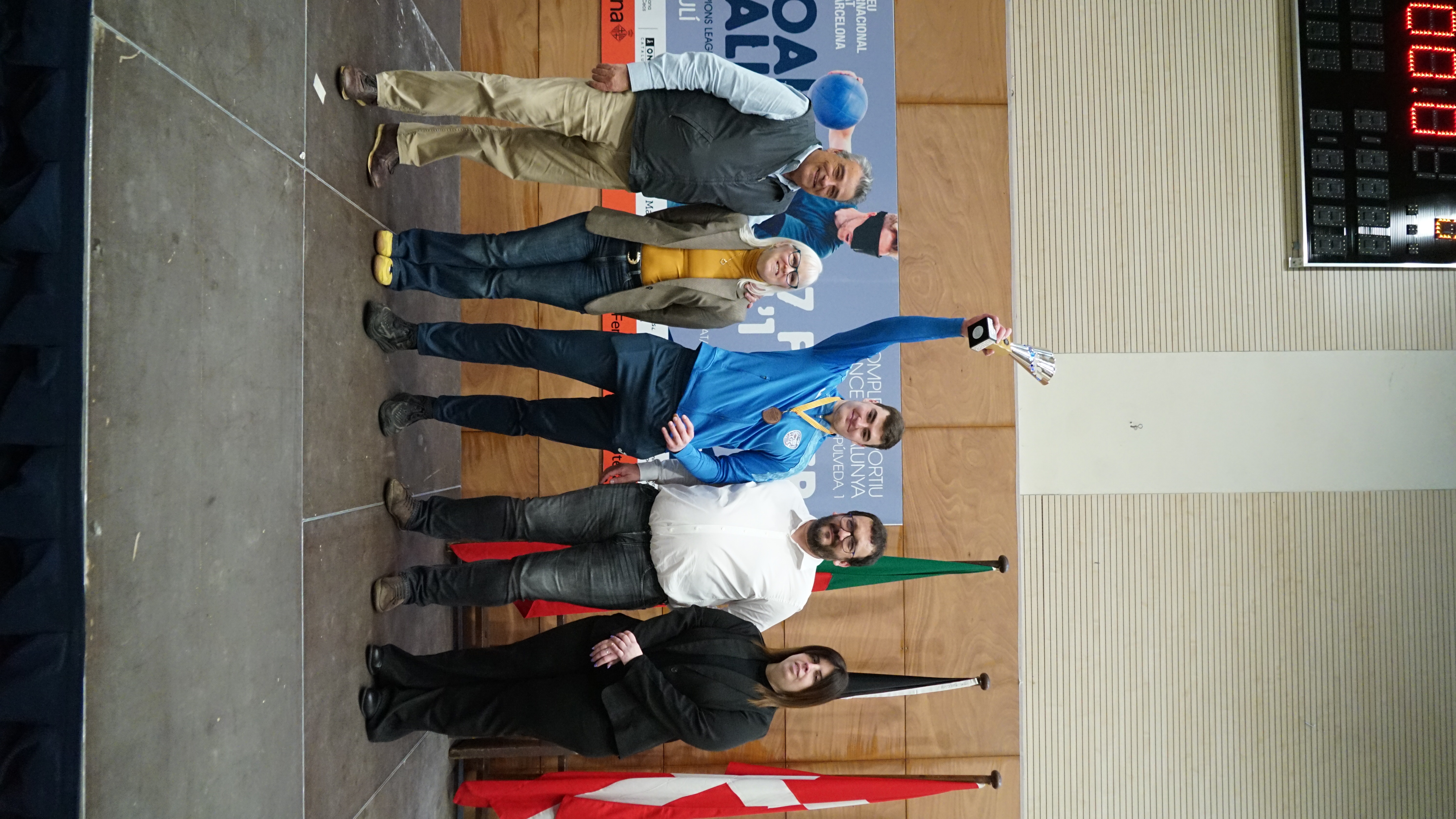 John Turloff on stage with event sponsors and partners raising his MVP trophy above his head
