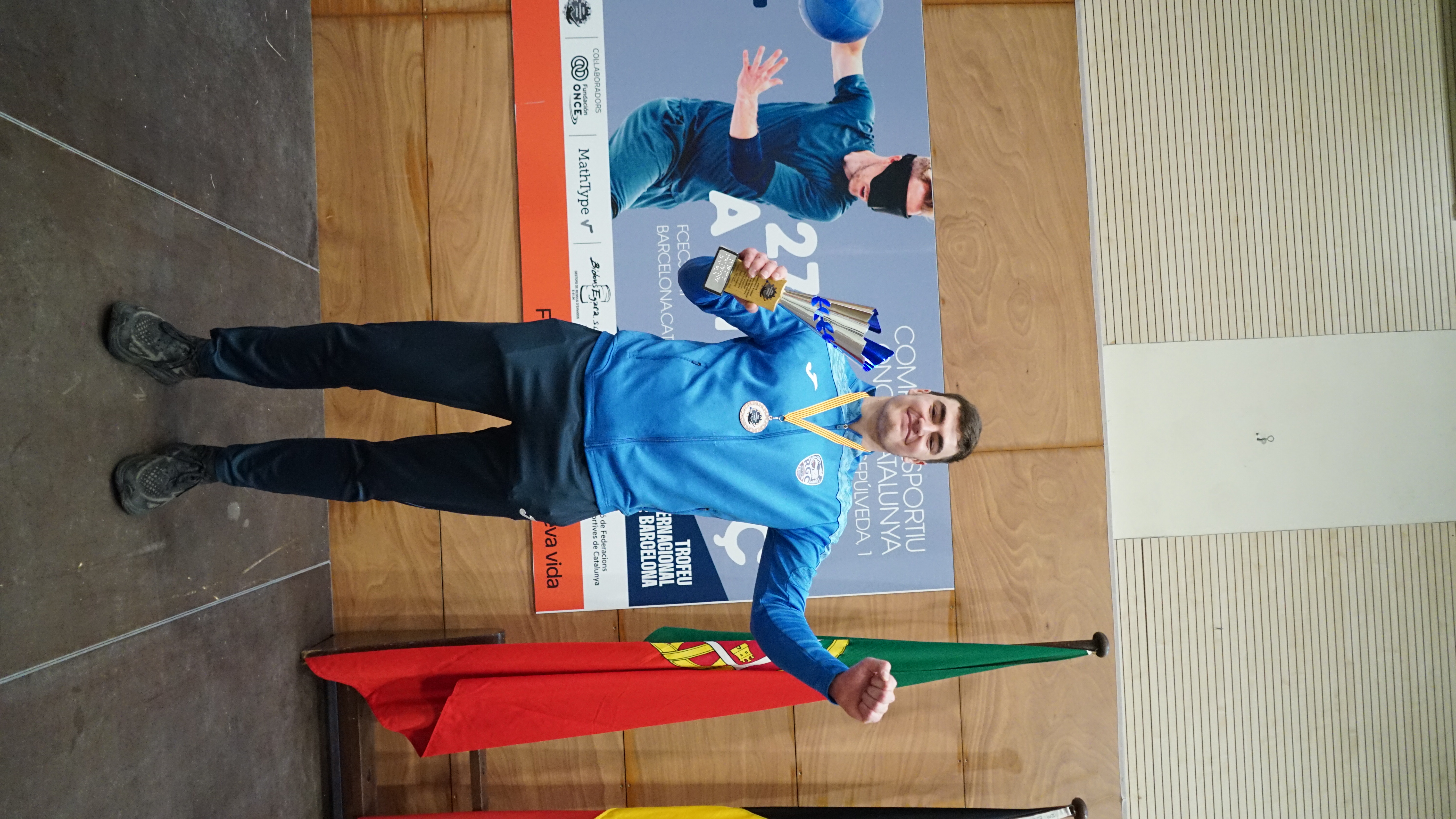 MVP John Turloff holding the trophy with his arms raised